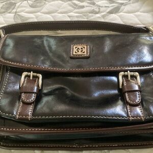 Black leather shoulder bag  with brown trim.